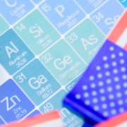 Bandeiras dos Estados Unidos e amostras de minerais cr&iacute;ticos colocadas em uma tabela peri&oacute;dica