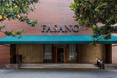 Foto da fachada do hotel Fasano em São Paulo, com o nome na frente, um toldo verde e árvores Foto da fachada do hotel Fasano em São Paulo, com o nome na frente, um toldo verde e árvores